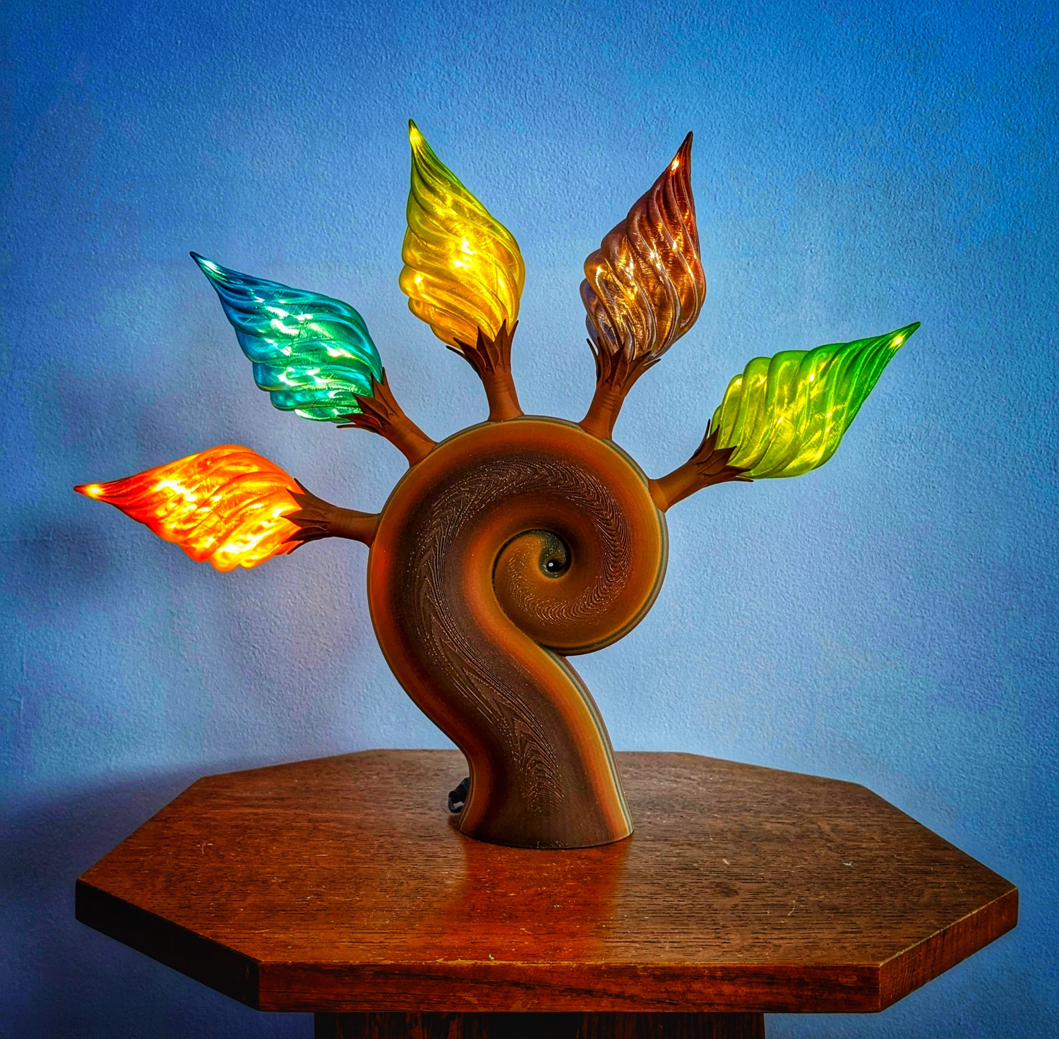 An Ember Spiral Sculpture on a wood table